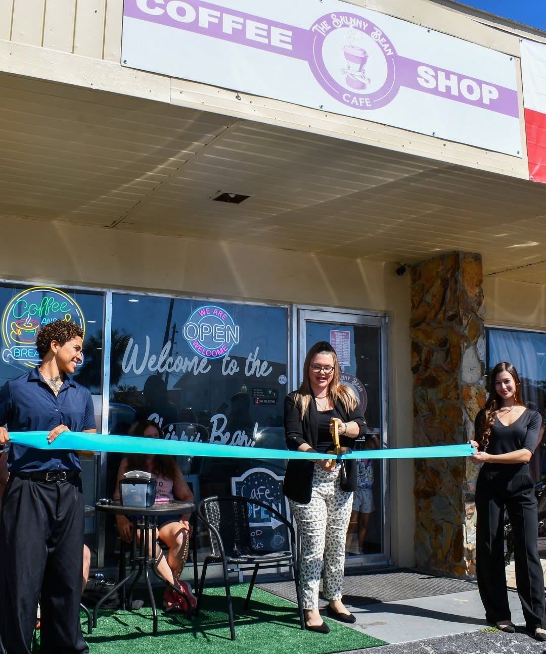 The Skinny Bean Cafe team cutting the ribbon on opening day in front of the shop